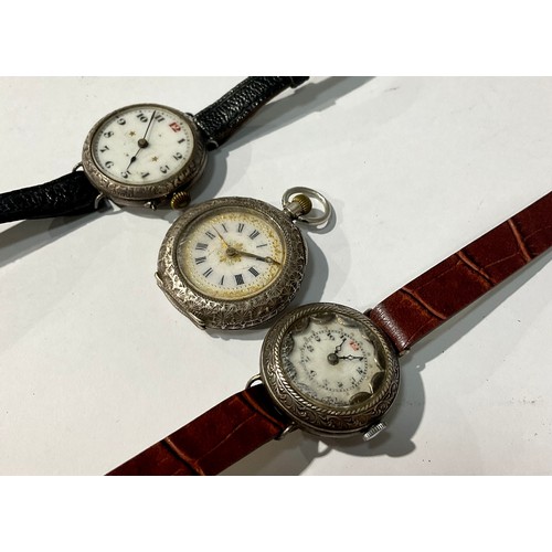 189 - An early 20th century silver wristwatch, Arabic numerals on a white dial, marked 925; another simila... 