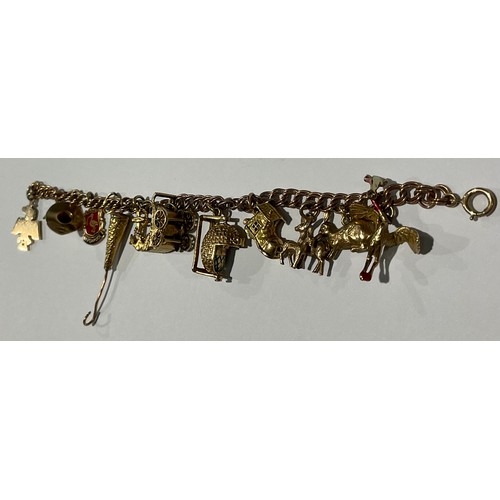 199 - A 9ct rose gold curb link charm bracelet, suspended with eleven 9ct gold charms including baby's cra... 