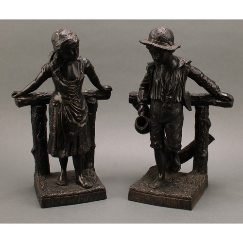 3070 - A pair of Bretby Art Pottery figures, glazed in bronze effect throughout, as a country boy and girl ... 