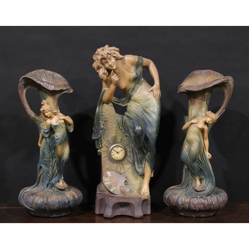 3025 - A French Art Nouveau plaster three piece clock garniture, the central figural clock modelled as a se... 