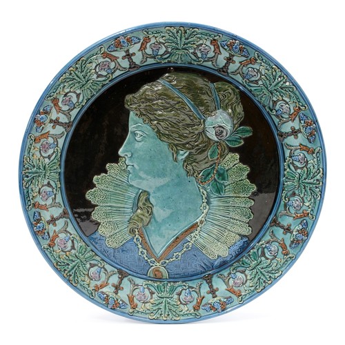 3091 - An Italian Maiolica circular charger, moulded in relief with a beauty in profile, in Renaissance dre... 