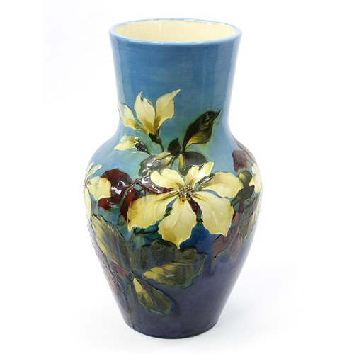 3028 - A large Burmantofts Faience baluster vase, impasto applied in low relief with magnolia blossom on a ... 