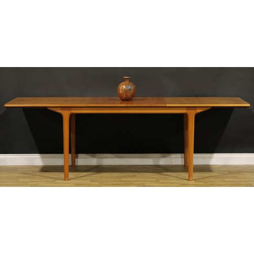 3356 - Mid-century Design - a teak extending dining table, probably A.H McIntosh, Kirkcaldy, two integral a... 