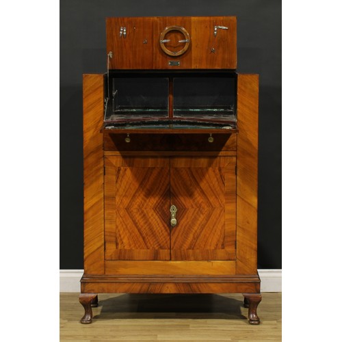 3327 - An Art Deco walnut cocktail cabinet, The Castle Cocktail Bar, hinged top and fall front above a pair... 