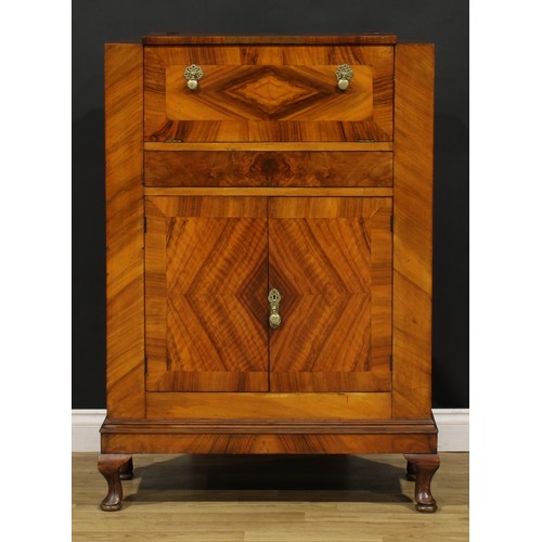 3327 - An Art Deco walnut cocktail cabinet, The Castle Cocktail Bar, hinged top and fall front above a pair... 