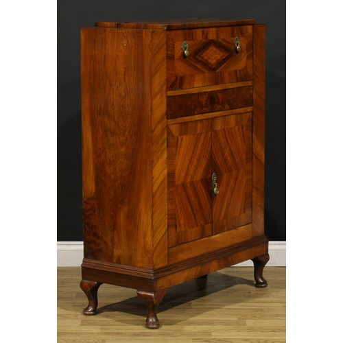 3327 - An Art Deco walnut cocktail cabinet, The Castle Cocktail Bar, hinged top and fall front above a pair... 