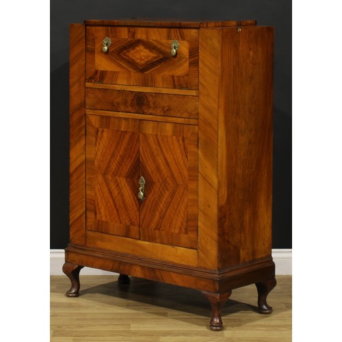 3327 - An Art Deco walnut cocktail cabinet, The Castle Cocktail Bar, hinged top and fall front above a pair... 