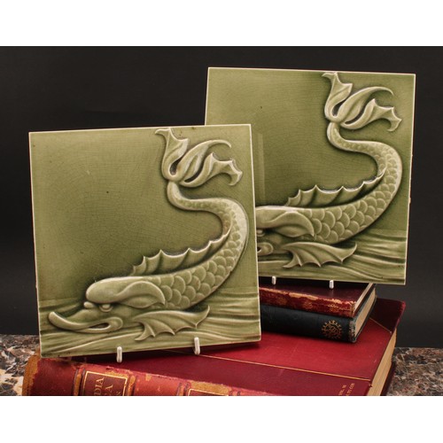 3056 - Wall Tiles - a pair of Maw wall tiles, applied in low relief with sea serpents, celadon glazed, each... 