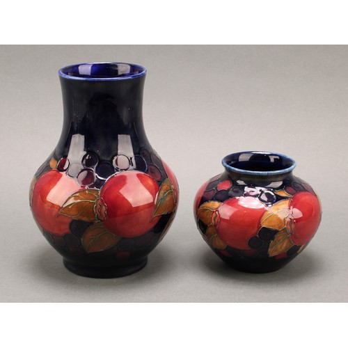 3126 - A Moorcroft Pomegranate pattern baluster vase, 17.5cm; another smaller Pomegranate pattern compresse... 