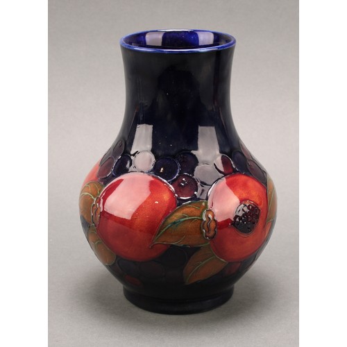 3126 - A Moorcroft Pomegranate pattern baluster vase, 17.5cm; another smaller Pomegranate pattern compresse... 