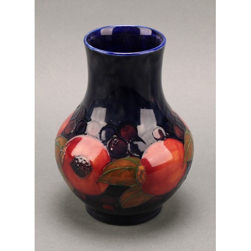 3126 - A Moorcroft Pomegranate pattern baluster vase, 17.5cm; another smaller Pomegranate pattern compresse... 