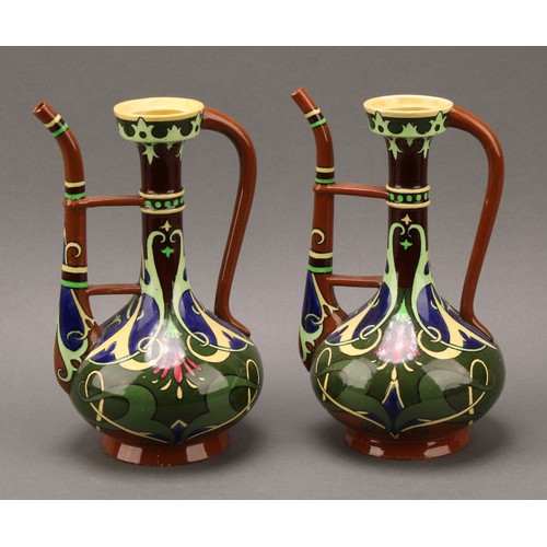 3136 - A pair of Shelley, Late Foley, Intarsio pattern ewers, decorated in polychrome with sinuous scrolls ... 