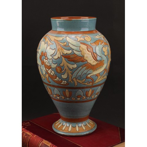 3018 - A CH Brannam Barnstaple inverted baluster vase, sgraffito incised with stylised griffin, 33cm high, ... 