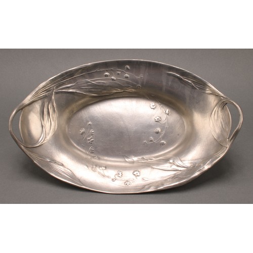 3314 - An Art Nouveau Kayserzinn pewter two handled oval dish, in relief with flowers, sinuous handles, 32c... 