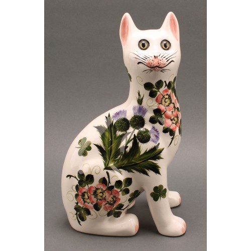 3033 - A pair of Griselda Hill Pottery ceramic cat models, painted with brightly coloured thistle and clove... 