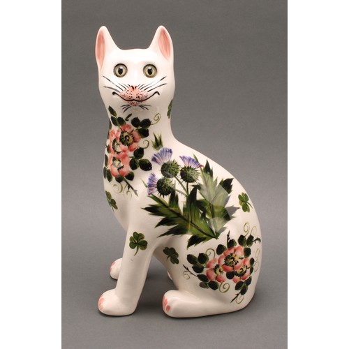 3033 - A pair of Griselda Hill Pottery ceramic cat models, painted with brightly coloured thistle and clove... 