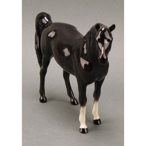 3067 - A Beswick model of a horse, Arab Xayal, in charcoal/black, model 1265, 16cm high, printed mark in go... 