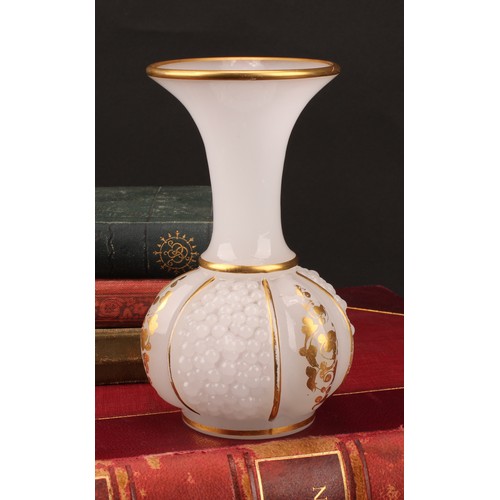 3221 - A late 19th century continental opaque white glass bottle vase, the body moulded with three panels o... 