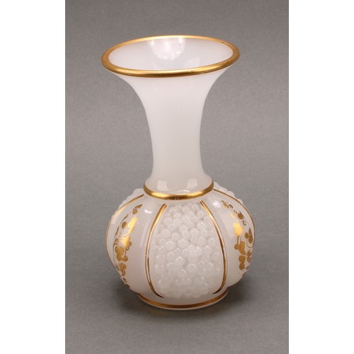 3221 - A late 19th century continental opaque white glass bottle vase, the body moulded with three panels o... 