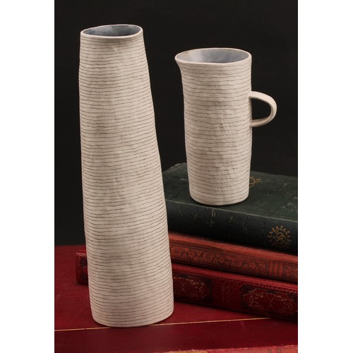 3215 - Susan Disley, a tall studio pottery slightly tapering cylindrical vase, 23cm high; a conforming cup,... 