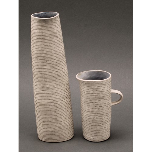 3215 - Susan Disley, a tall studio pottery slightly tapering cylindrical vase, 23cm high; a conforming cup,... 