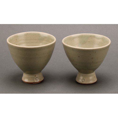 3187 - A Leach Pottery sake carafe and stopper with pair of conical sake glasses, glazed in celadon green, ... 