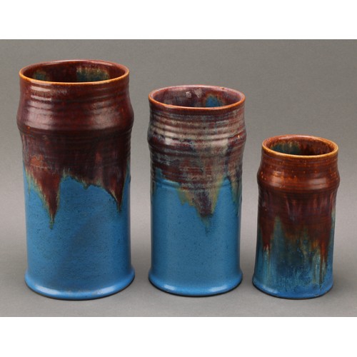 3097 - A graduated trio of Bourne Denby Danesby Orient Ware Brassington ribbed cylindrical vases, the large... 