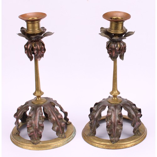 3251 - A pair of Arts and Crafts copper and brass candlesticks, in the manner of W A S Benson, each drip pa... 