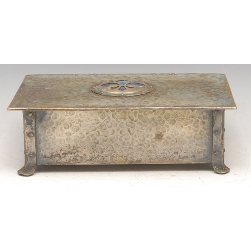 3256 - An Arts and Crafts enamel mounted rectangular casket, hinged cover centred by a fleur-de-lys in mott... 