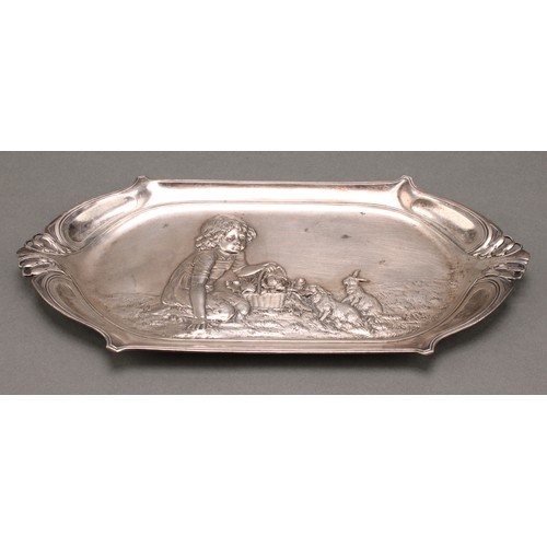 3252 - A WMF Art Nouveau card tray, the field embossed with a young girl feeding rabbits, 27.5cm wide, desi... 