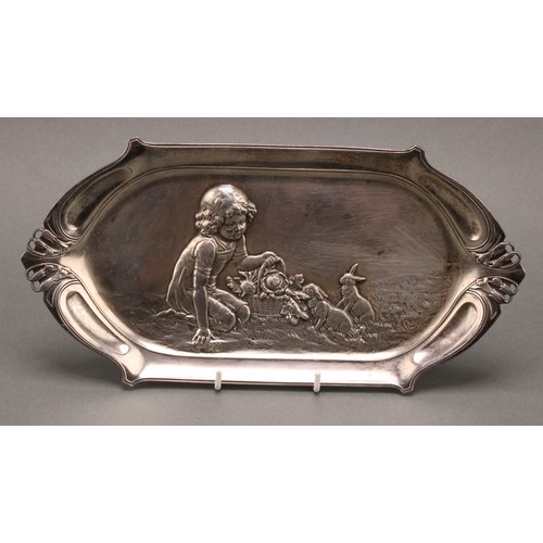 3252 - A WMF Art Nouveau card tray, the field embossed with a young girl feeding rabbits, 27.5cm wide, desi... 