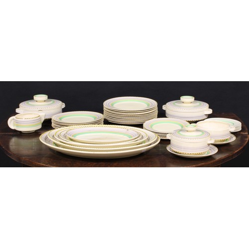 3011 - An Art Deco Clarice Cliff dinner service, painted in bands of green, yellow and black on a honey gla... 