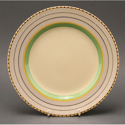 3011 - An Art Deco Clarice Cliff dinner service, painted in bands of green, yellow and black on a honey gla... 