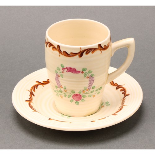 3004 - A Clarice Cliff coffee set, painted with floral garlands on a honey glaze ground, comprising ribbed ... 