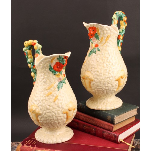 3009 - A pair of Clarice Cliff Celtic Harvest pattern jugs, moulded with wheatsheaves on a honey glaze grou... 