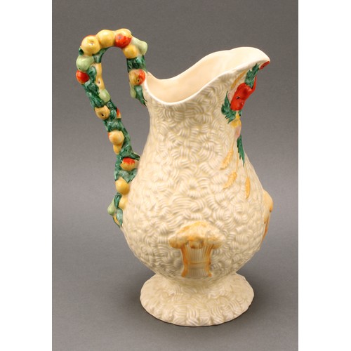 3009 - A pair of Clarice Cliff Celtic Harvest pattern jugs, moulded with wheatsheaves on a honey glaze grou... 