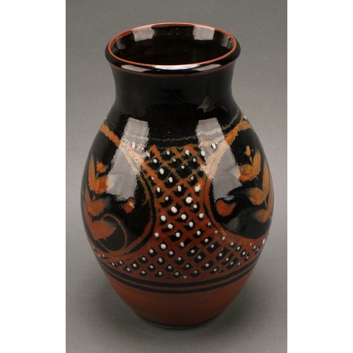 3212 - Studio Pottery - Derek Emms (1929-2004), a tenmoku and kaki glaze ovoid vase, decorated with stylise... 