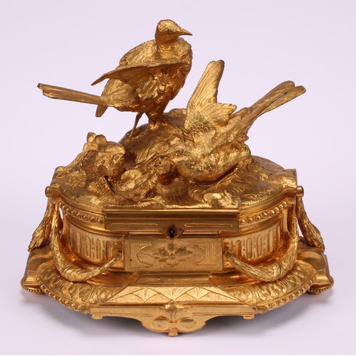 3310 - A 19th century French gilt bronze jewellery box, the hinged cover sculptured with birds by a rocky o... 