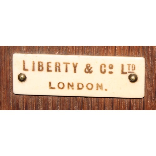 3418 - Liberty & Co - a set of Arts and Crafts oak 
wall shelves, 72cm high, 78cm wide, ivorine label to ve... 