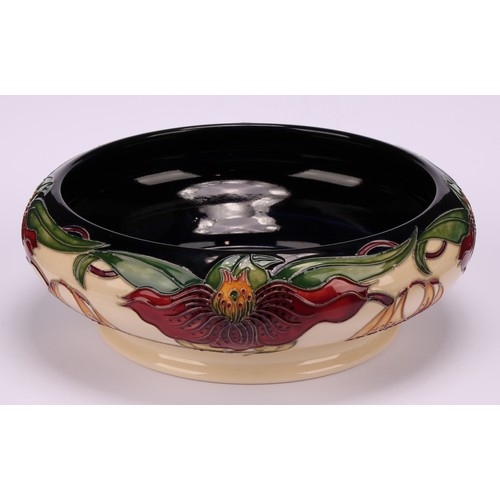 3108 - A modern Moorcroft pottery bowl in the Anna Lily pattern, designed by Nicola Slaney, of squat should... 