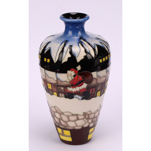 3112 - A Moorcroft baluster vase decorated with Santa in terraced street in the potteries, impressed and mo... 