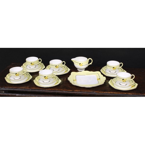 3037 - A Paragon Art Deco tea service, decorated with panels of stylised flowers, on a yellow ground, a rep... 