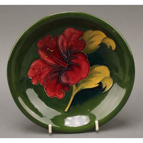 3119 - A Moorcroft Hibiscus pattern circular plate, 26cm diameter, monogrammed, impressed mark; a Moorcroft... 