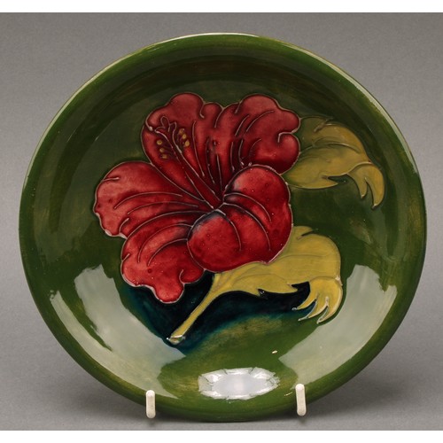 3119 - A Moorcroft Hibiscus pattern circular plate, 26cm diameter, monogrammed, impressed mark; a Moorcroft... 