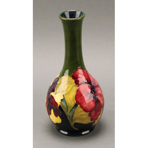 3120 - A Moorcroft Hibiscus pattern ovoid bottle vase, 21.5cm high, monogrammed, impressed mark; another, s... 