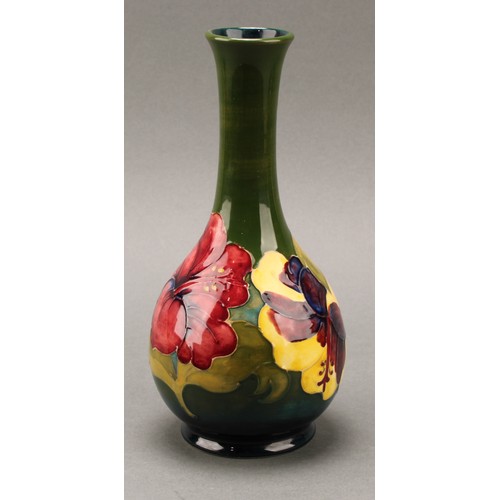 3120 - A Moorcroft Hibiscus pattern ovoid bottle vase, 21.5cm high, monogrammed, impressed mark; another, s... 