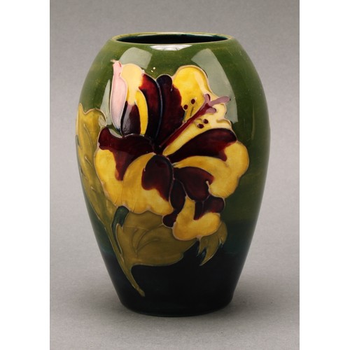 3120 - A Moorcroft Hibiscus pattern ovoid bottle vase, 21.5cm high, monogrammed, impressed mark; another, s... 