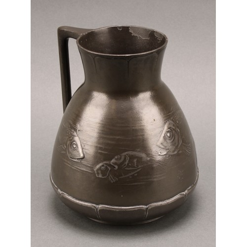 3313 - A German Jugenstil Kayserzinn pewter jug, moulded with a shoal of fish, lily pad borders, angular ha... 