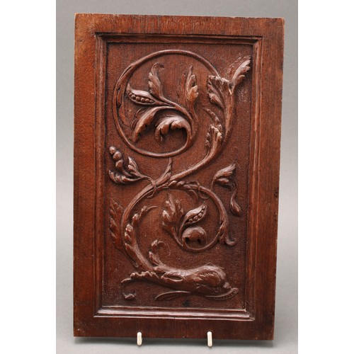 3335 - A mahogany pokerwork panel, carved with a stylised sea serpent and scrolling seaweed, 32cm x 20.5cm,... 