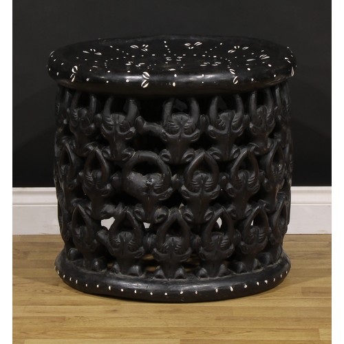 3360 - Tribal Art & the Eclectic Interior - a Bamileke stool, dished circular top, the side pierced and car... 